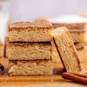 Snickerdoodle Cookie Bar leaning up against a stack