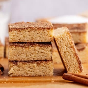 Snickerdoodle Cookie Bar leaning up against a stack