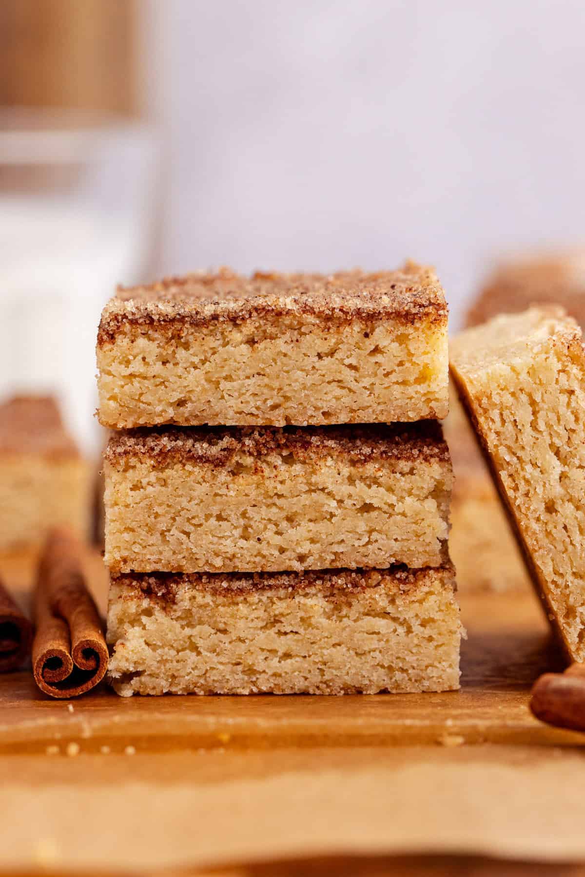 Snickerdoodle Cookie Bars stacked on parchment paper