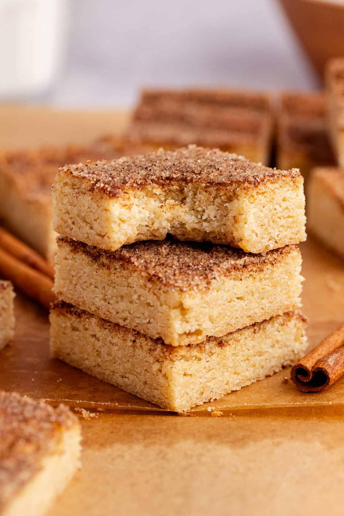 Snickerdoodle Cookie Bars Stacked with a bite taken