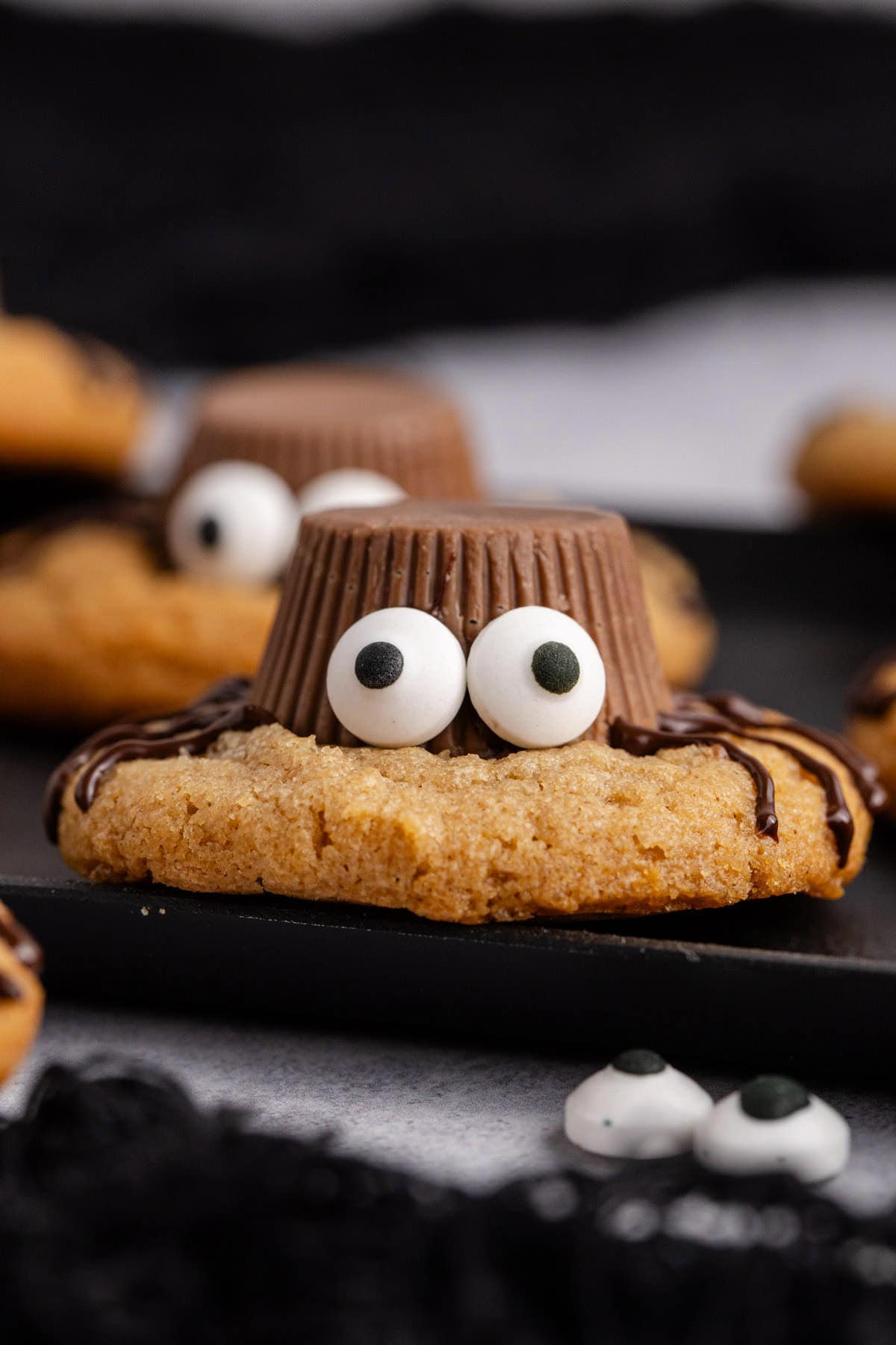 Spider Cookies close up on a black tray