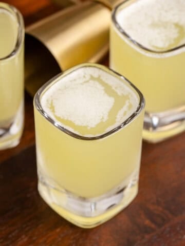 Tic Tac Shots in Shot Glasses on a Wooden Tray from above