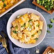 Buffalo Chicken Casserole from above in a bowl with blue cheese crumbles and green onions