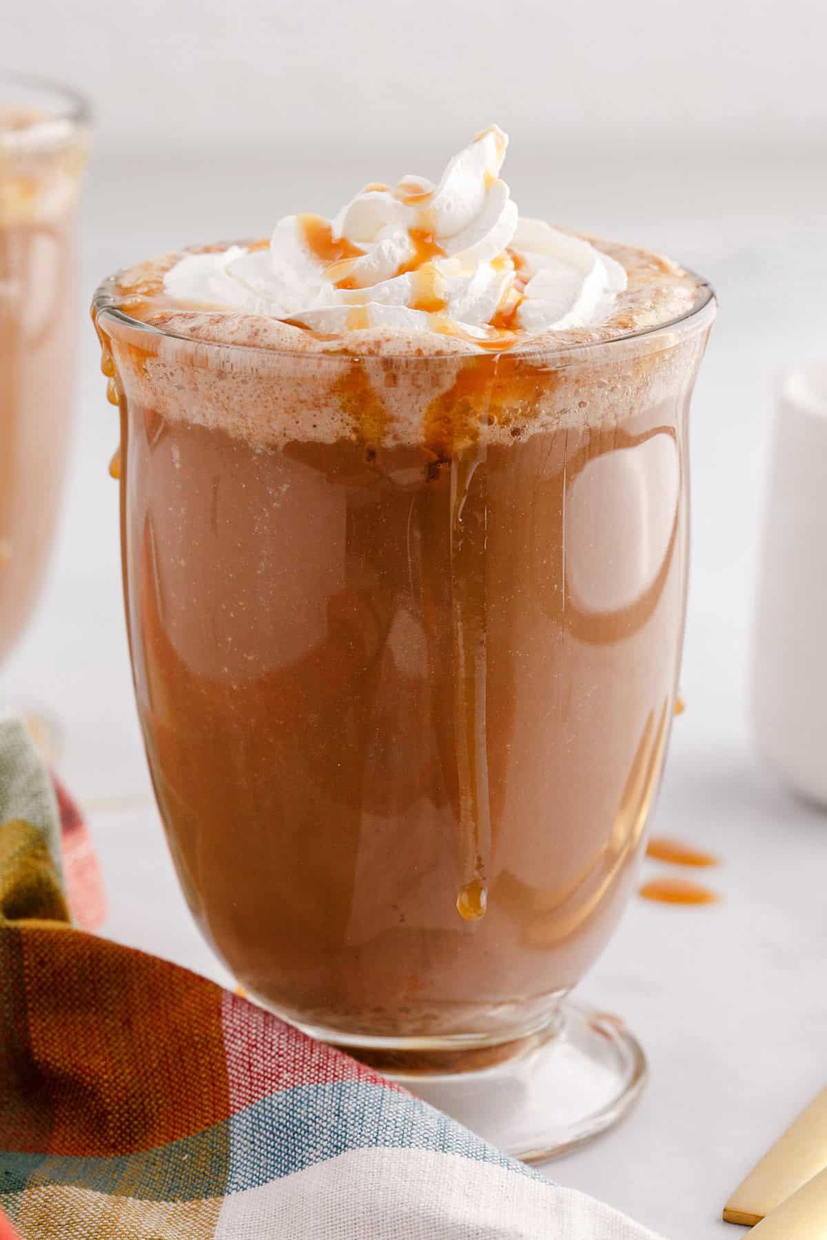Caramel Mocha Coffee Served in a Clear Mug and Topped with Whipped Cream and Caramel Sauce Drizzle