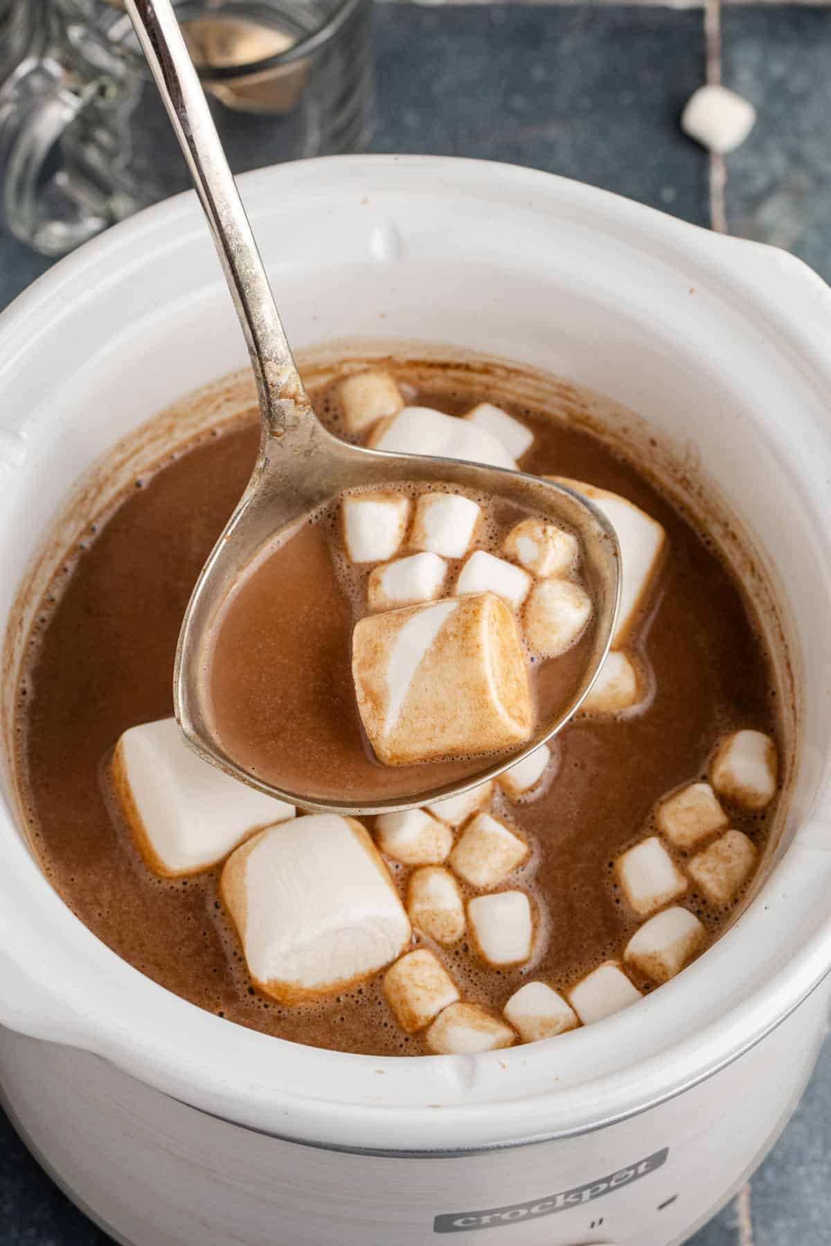 Overhead of Crockpot Hot Chocolate with Mini and Regular Marshmallows Being Scooped with a Ladle