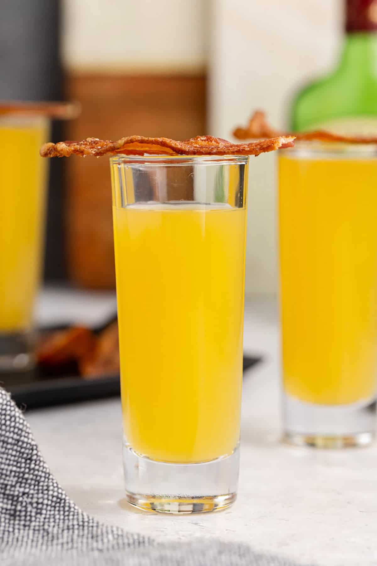 Breakfast Shot in a Clear Shot Glass Topped with Piece of Bacon
