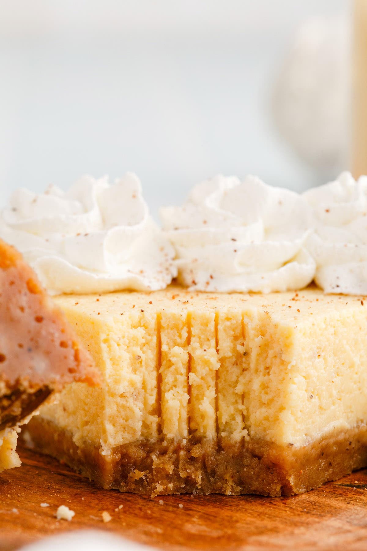 Eggnog Recipes Instant Pot Eggnog cheesecake slice up close with fork marks