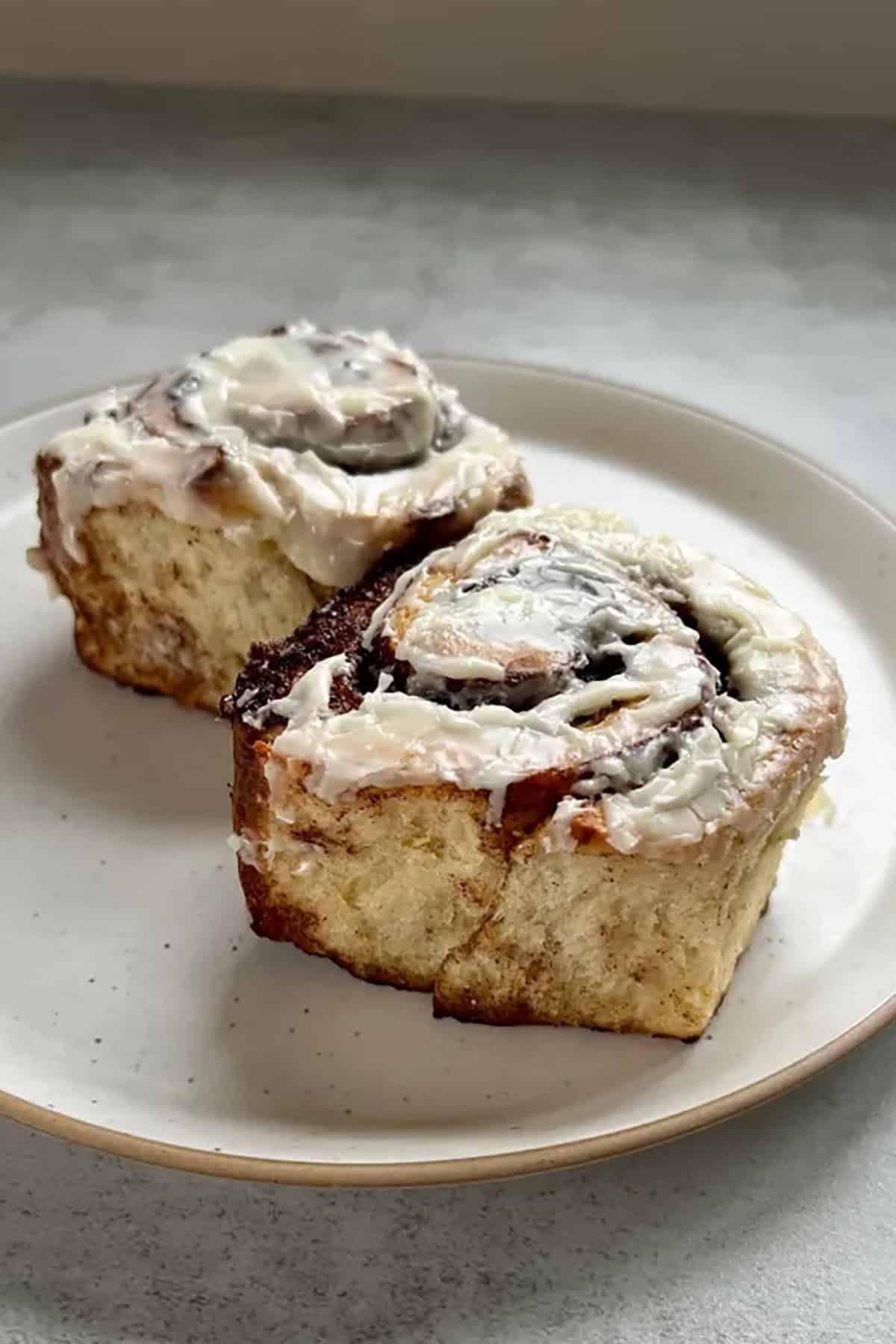 Eggnog Recipes plated Eggnog Cinnamon Rolls with icing on them