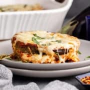 Eggplant Casserole on a plate with basil garnish