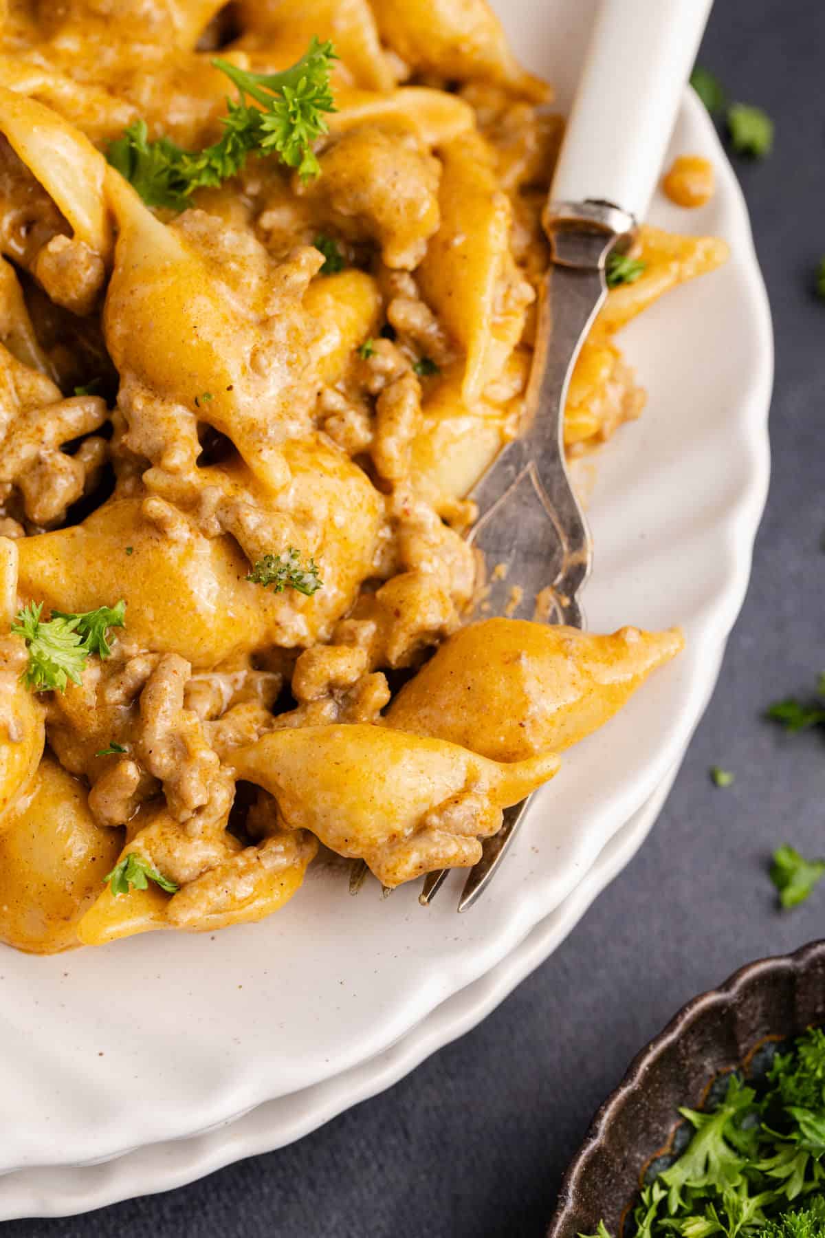 Homemade Hamburger Helper taco version on a plate close up with noodles on a fork