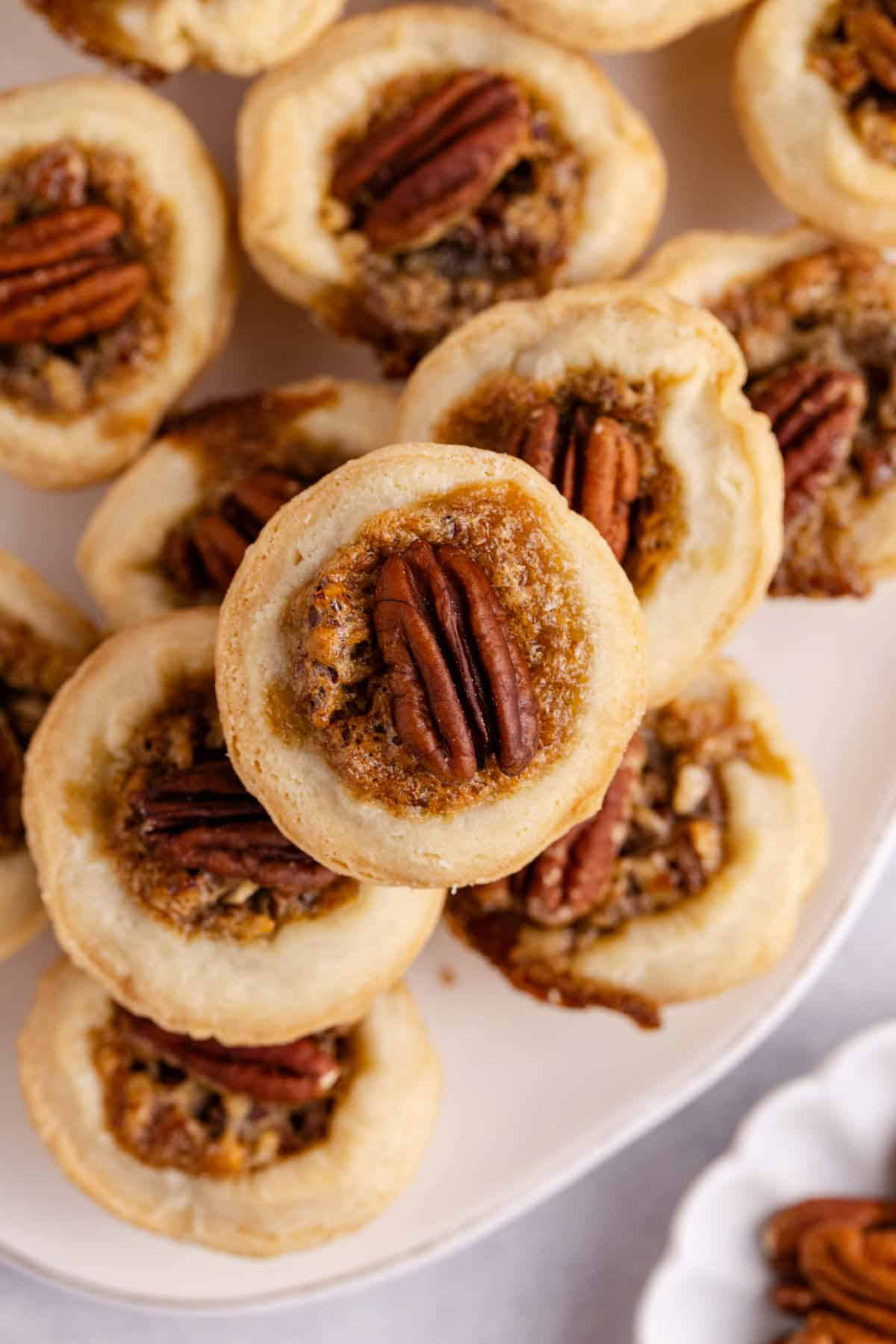 Mini Pecan Pies stacked on a platter from above