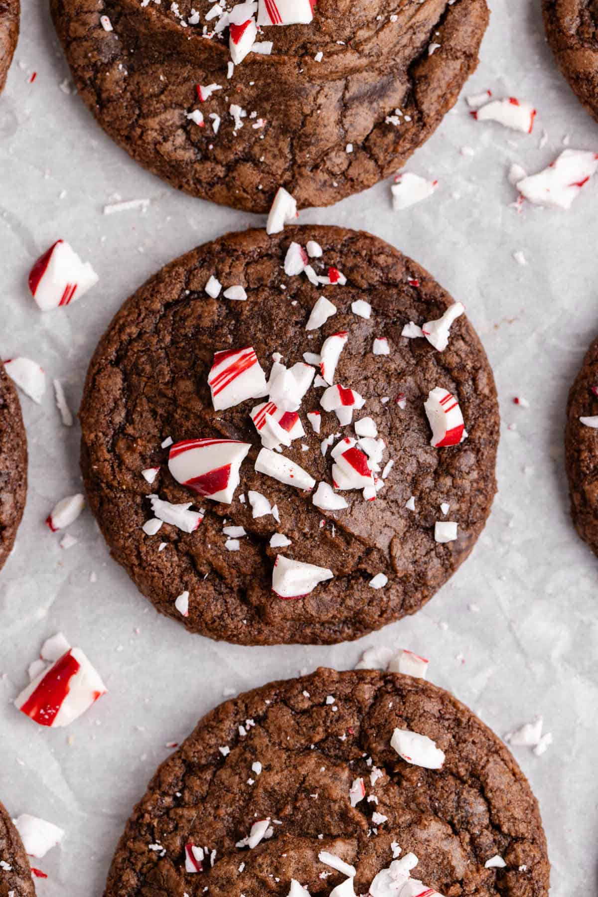 Peppermint Brownie Cookies on parchment paper with crushed peppermint on top