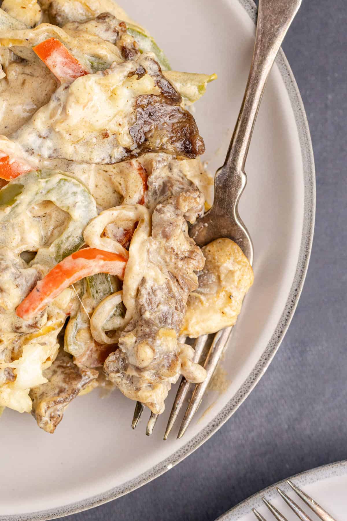 Philly Cheesesteak Casserole close up on a plate with a fork