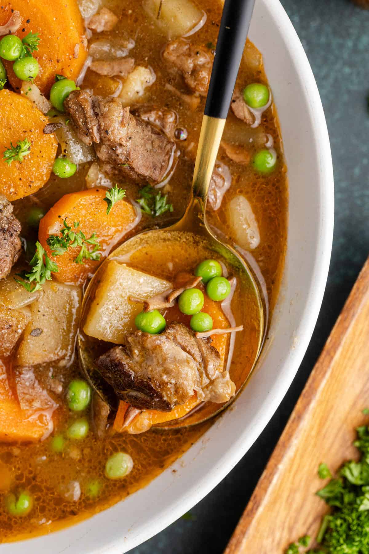 Slow Cooker Beef Stew in a bowl with a close up of a spoon
