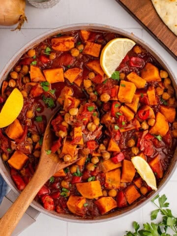 Overhead of Sweet Potato Skillet with Fresh Parsley and Lemon Wedge Garnishes