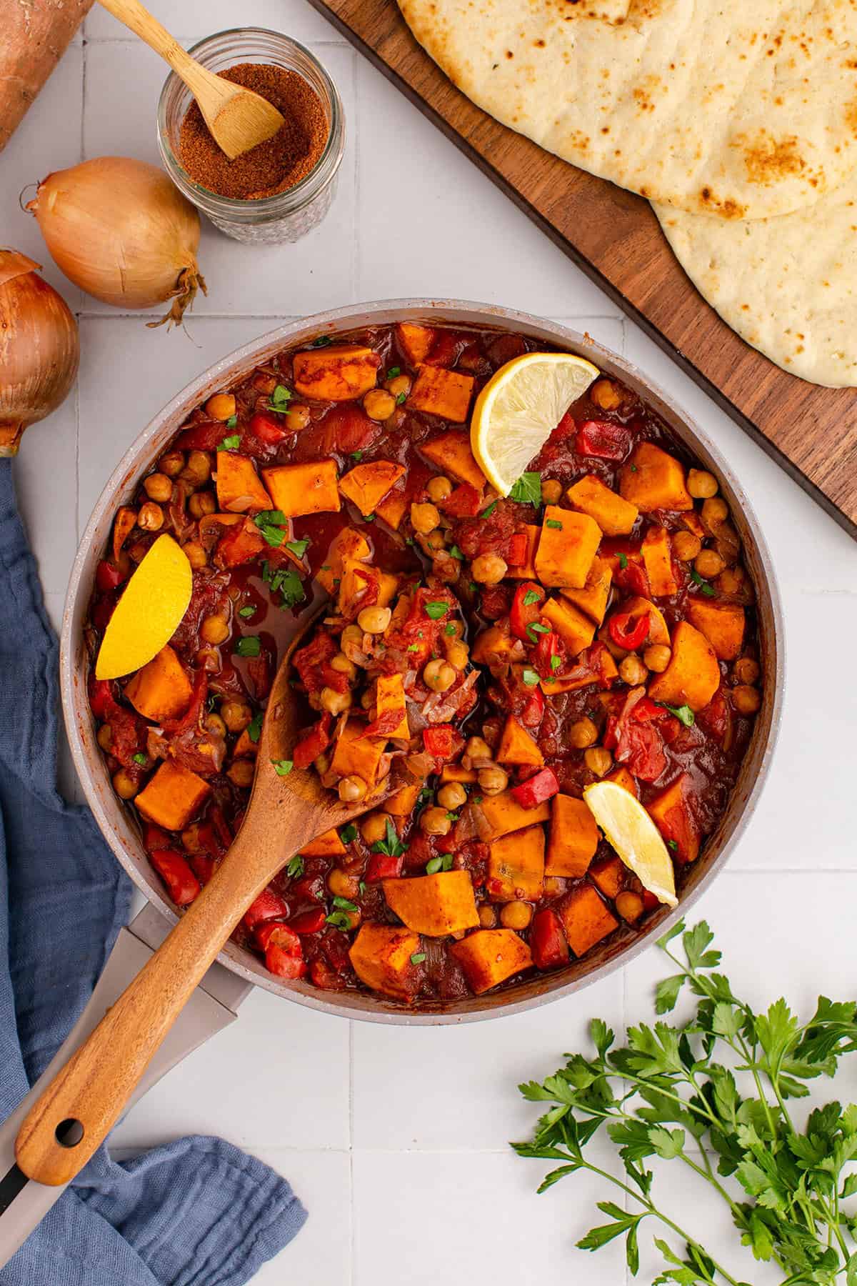 Overhead of Sweet Potato Skillet with Fresh Parsley and Lemon Wedge Garnishes