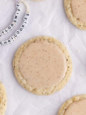 Taylor Swift Chai Cookies on parchment paper with friendship bracelets