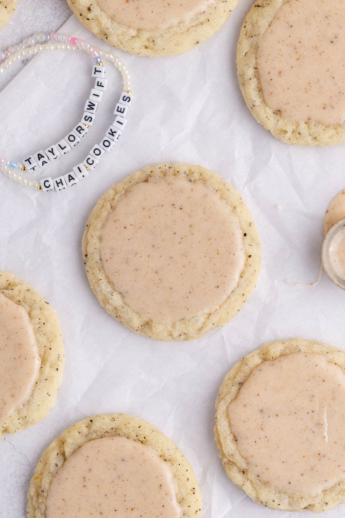 Taylor Swift Chai Cookies on parchment paper with friendship bracelets