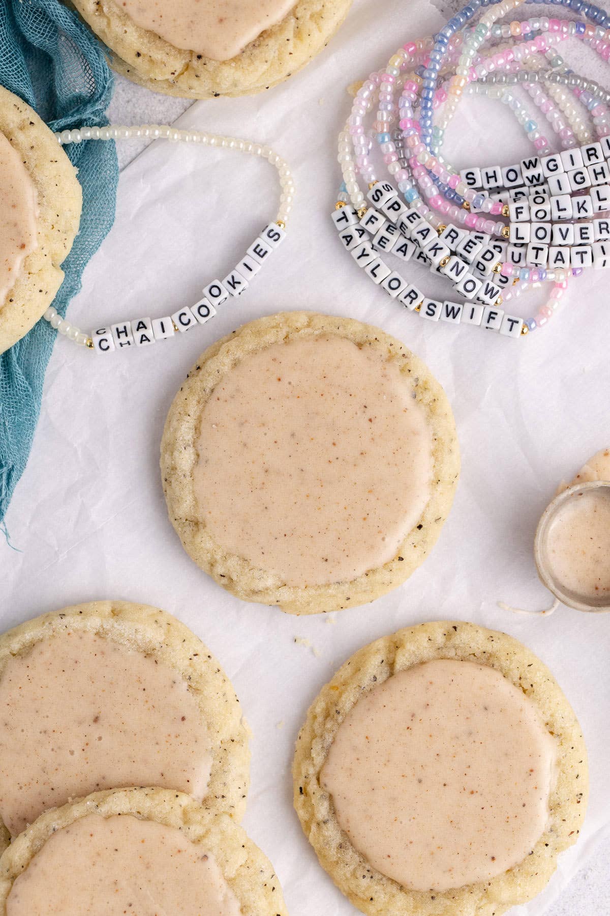 Taylor Swift Chai Cookies on parchment paper with friendship bracelets