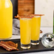 Breakfast Shot in Shot Glasses with Orange Juice in the Back