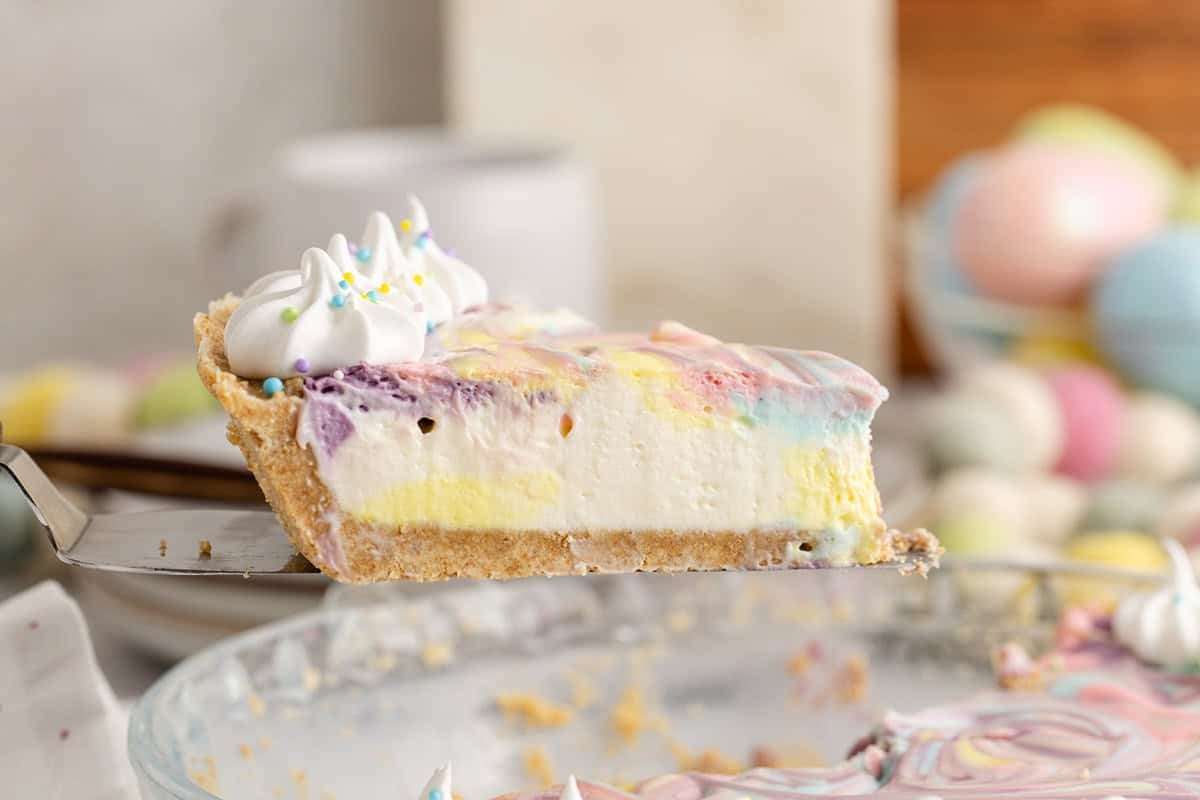 Easter Swirl Cheesecake slice on a pie server