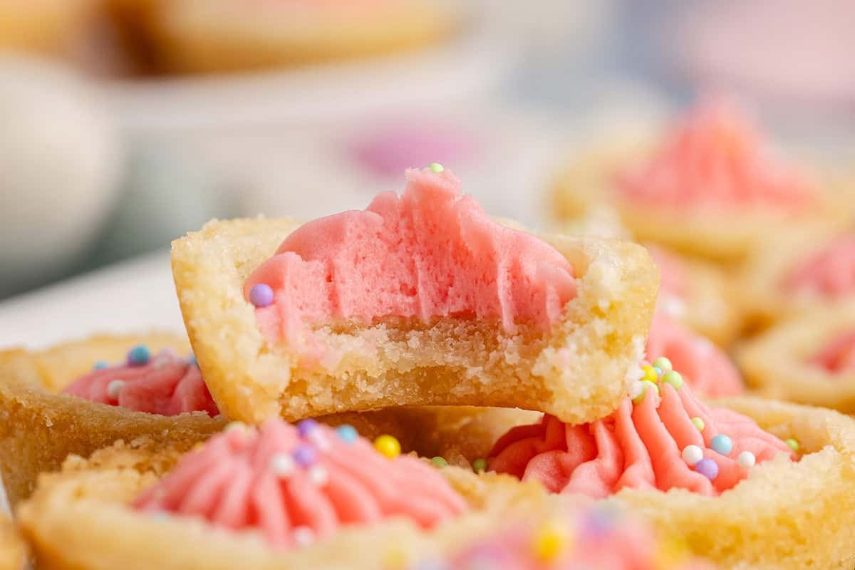 Easter Sugar Cookie Cups stacked with a bite taken