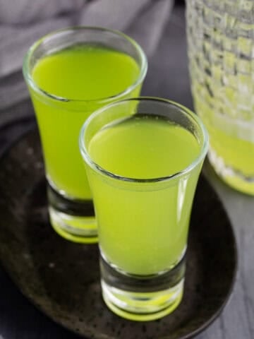 Melon Ball Shots on a tray with cocktail shaker