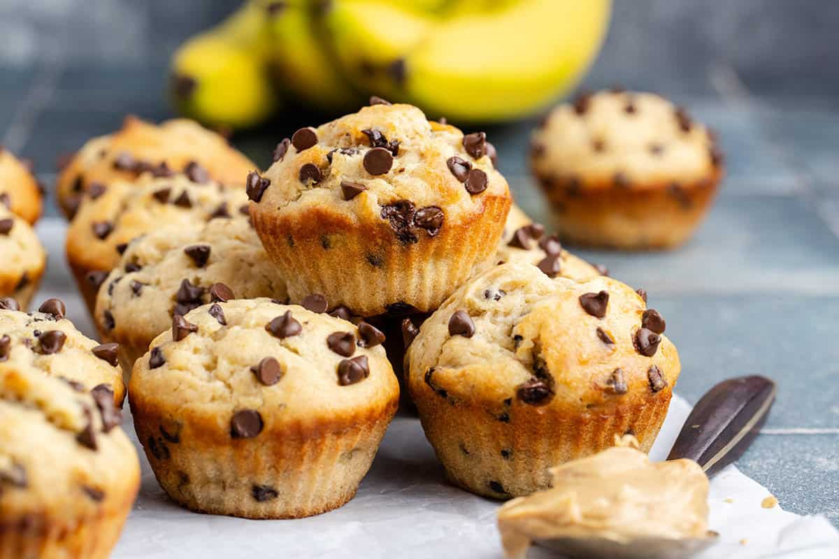Peanut Butter Banana Muffins piled on a parchment paper