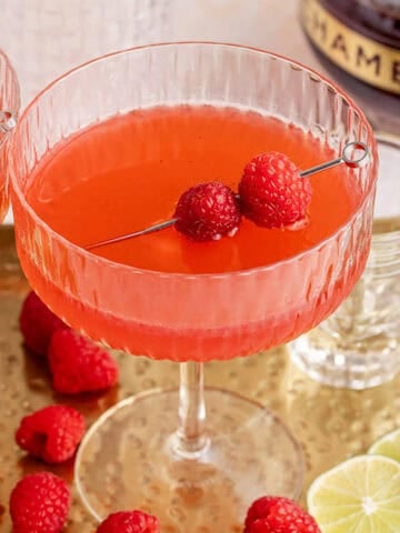 Raspberry Martinis on a tray with raspberry garnish
