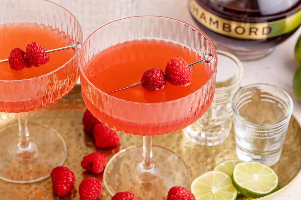 Raspberry Martinis on a tray with raspberry garnish