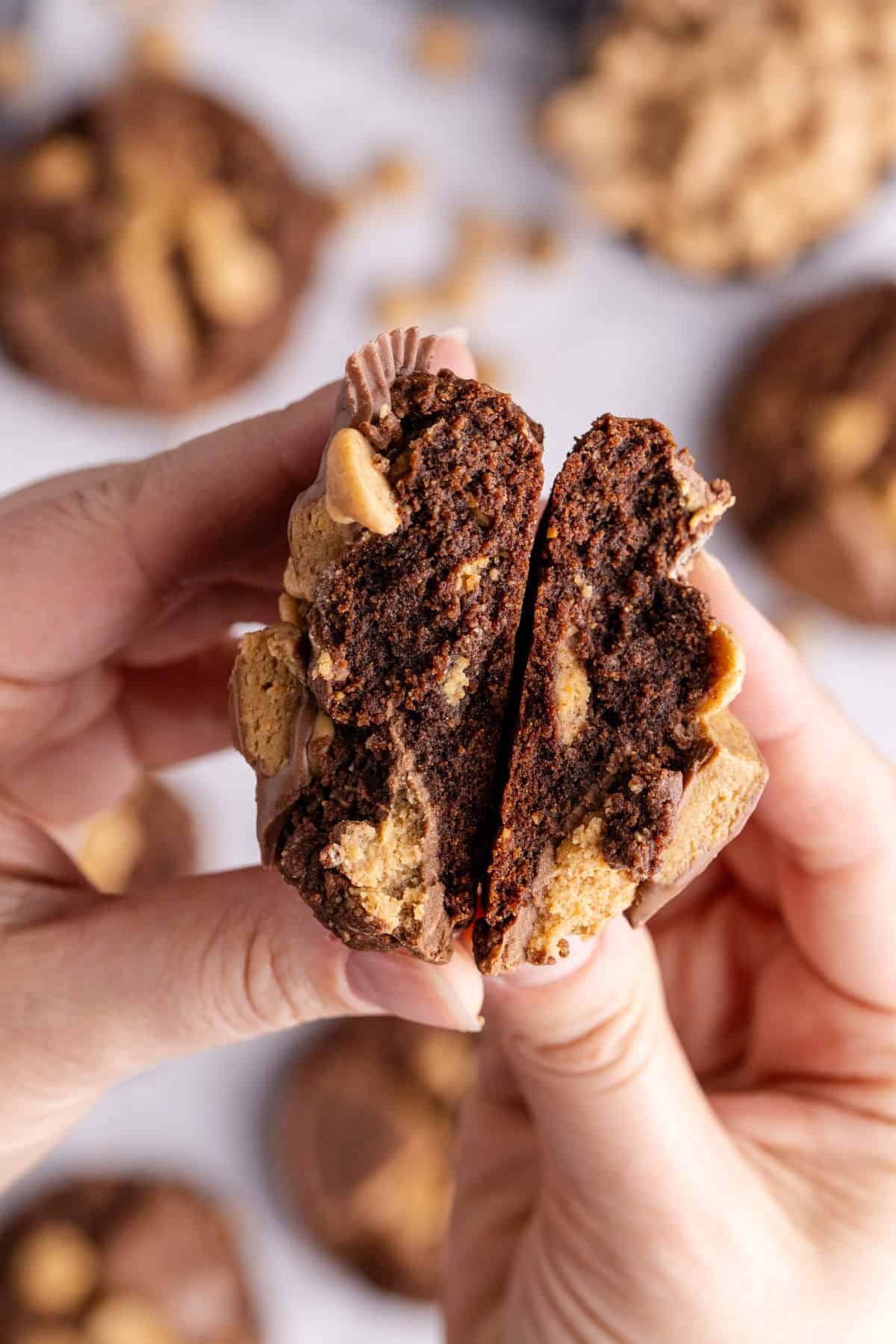 Reese's Peanut Butter Cookie being held with two halves facing above