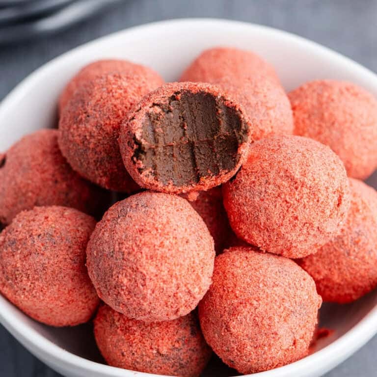 Strawberries Chocolate Truffles in a bowl with a bite out of one