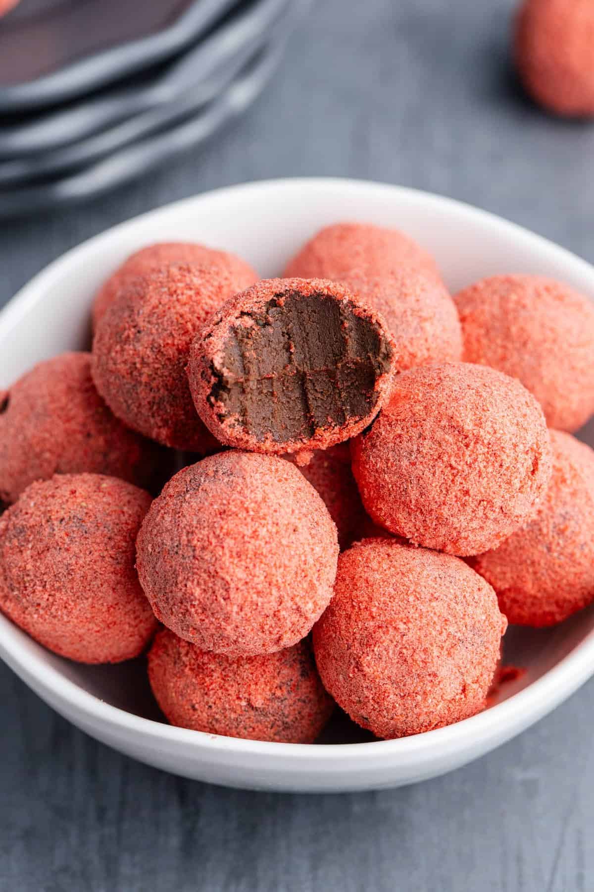 Strawberries Chocolate Truffles in a bowl with a bite out of one