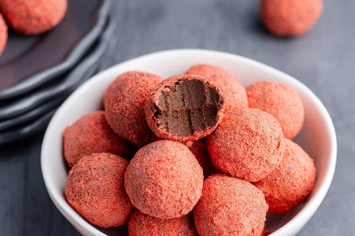Strawberries Chocolate Truffles in a bowl with a bite out of one