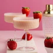Strawberries and Cream Martini in coup glasses on a cutting board