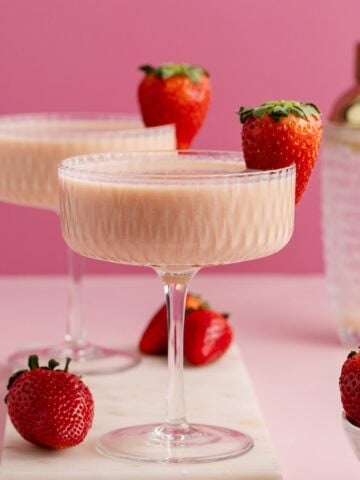 Strawberries and Cream Martini in coup glasses on a cutting board