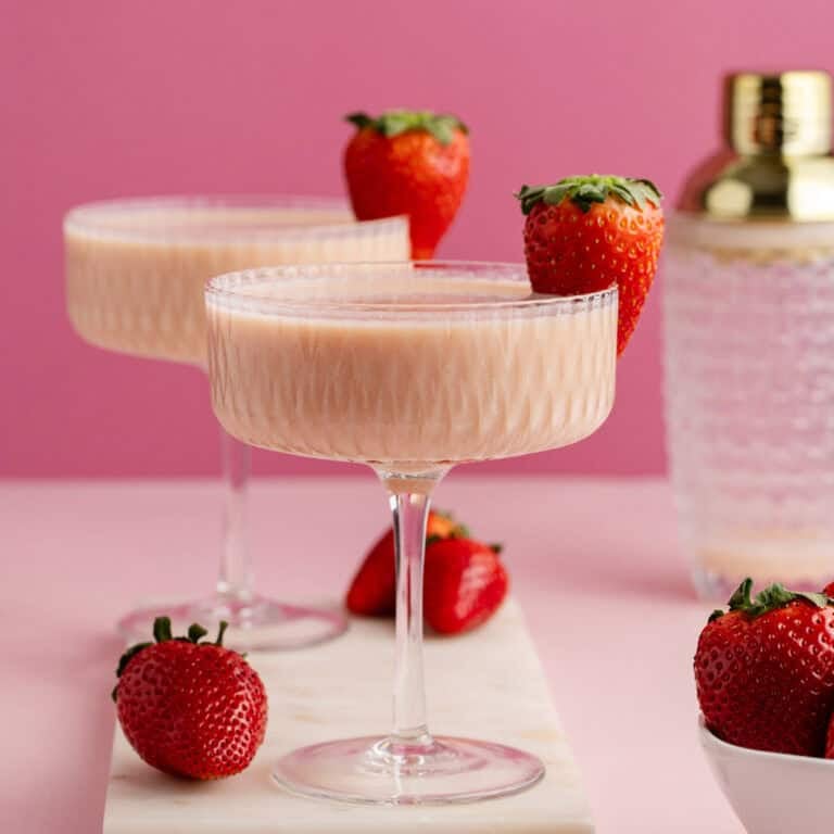 Strawberries and Cream Martini in coup glasses on a cutting board