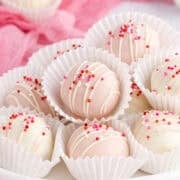Valentine’s Day Truffles in white sleeves piled on a platter