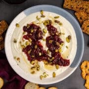 Whipped Goat Cheese in a bowl garnished from above with crackers around