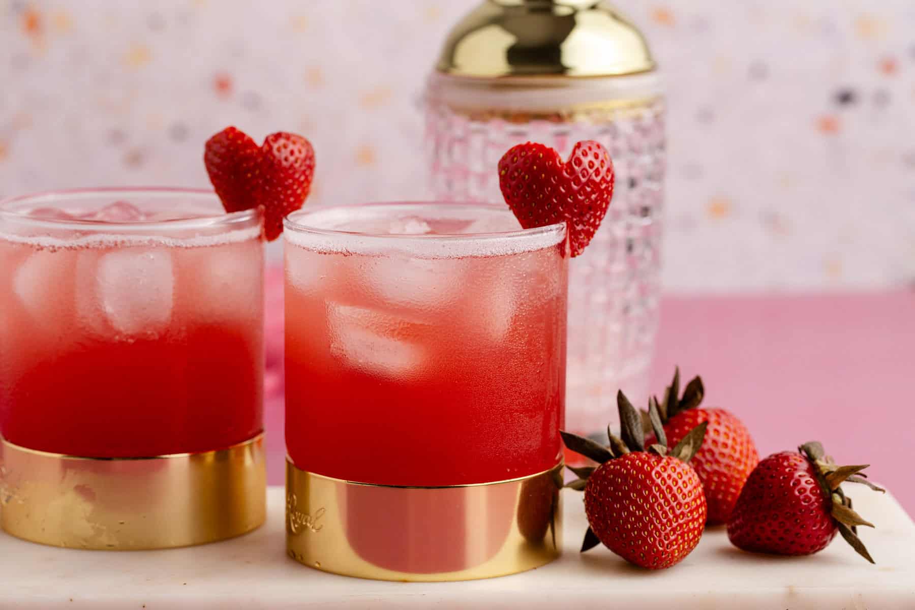 Love Bug Cocktail on a tray with a cocktail shaker in the back