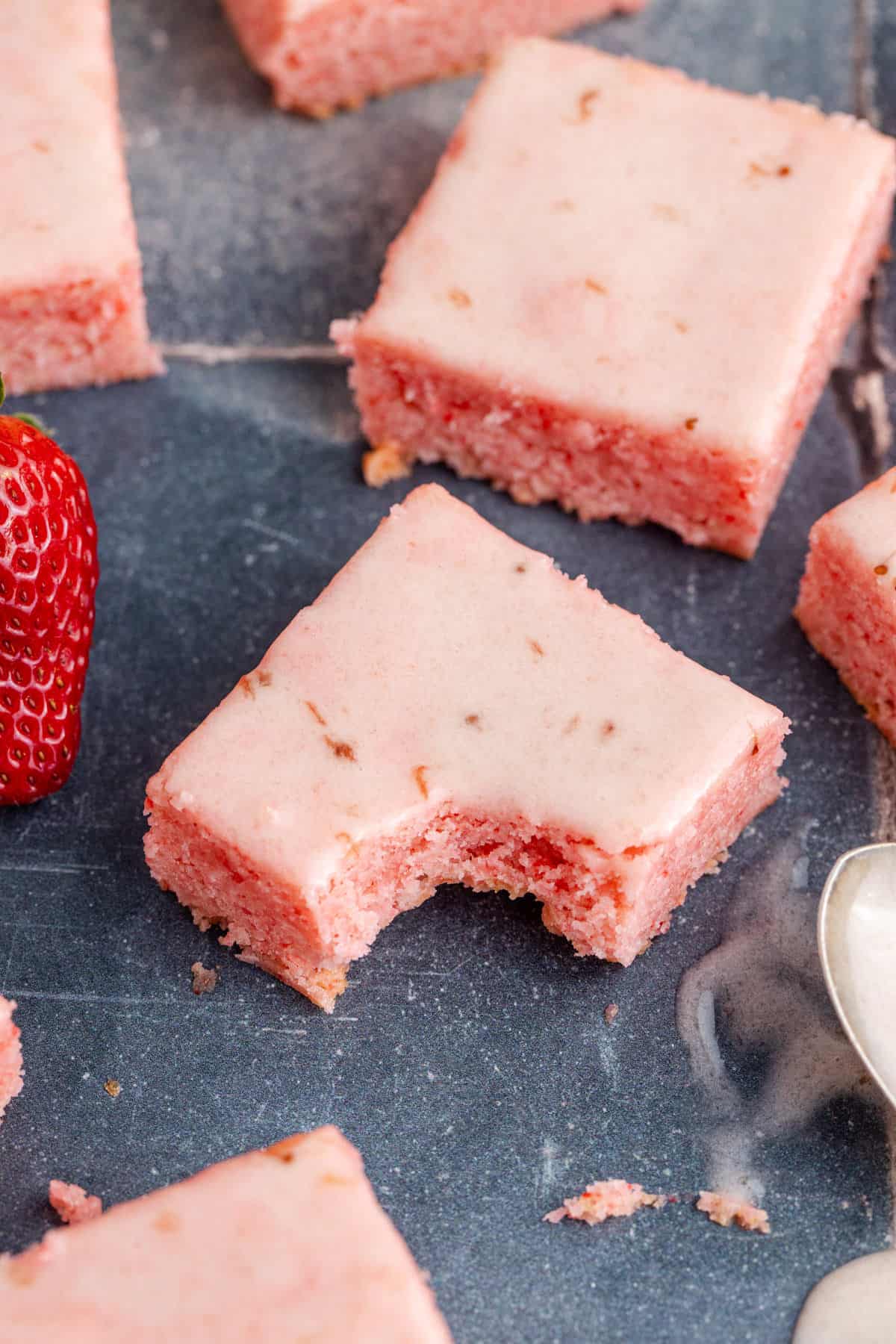 Strawberry Brownies on a counter with a bite taken