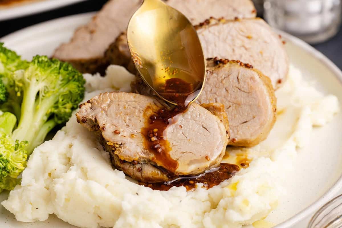 Instant Pot Pork Tenderloin with sauce being poured on up close