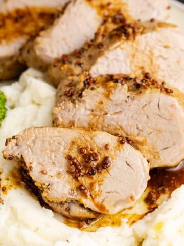 Instant Pot Pork Tenderloin on a bed of mashed potatoes up close