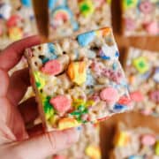 Lucky Charms Rice Krispies Treat square being picked up, up close