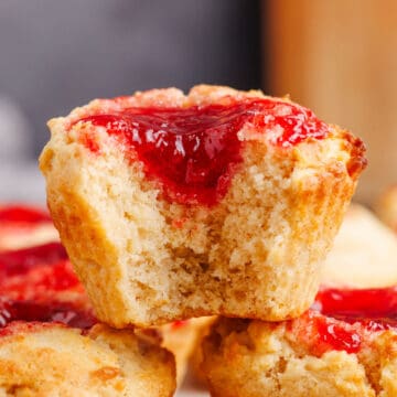 Peanut Butter and Jelly Muffins stacked with a bite taken up close