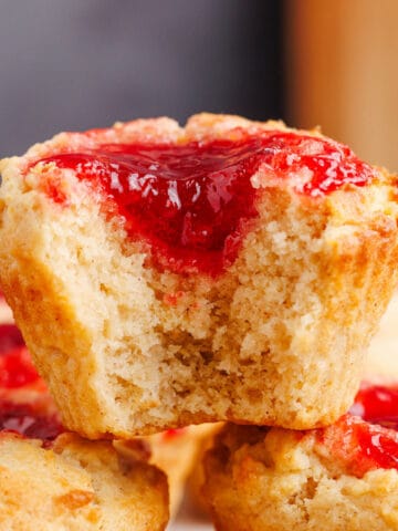 Peanut Butter and Jelly Muffins stacked with a bite taken up close