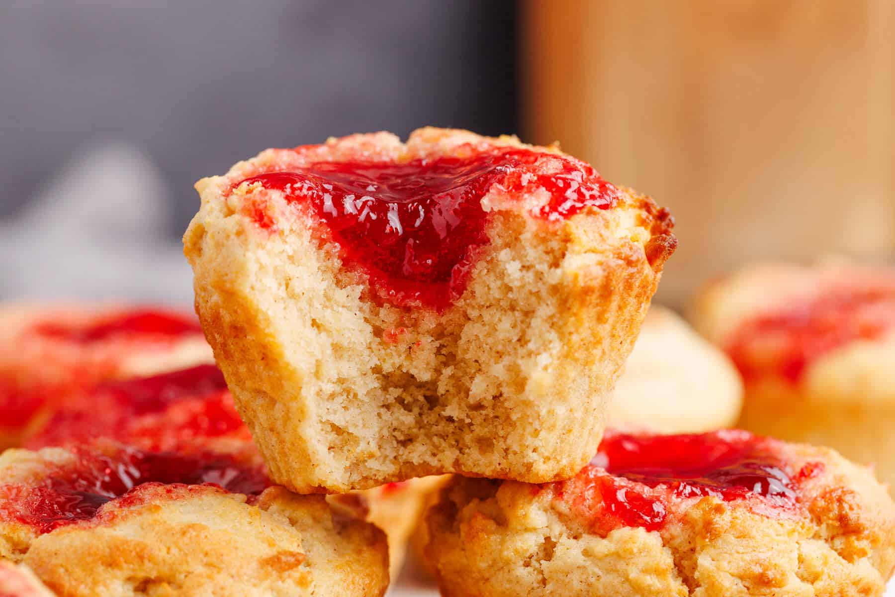 Peanut Butter and Jelly Muffins stacked with a bite taken