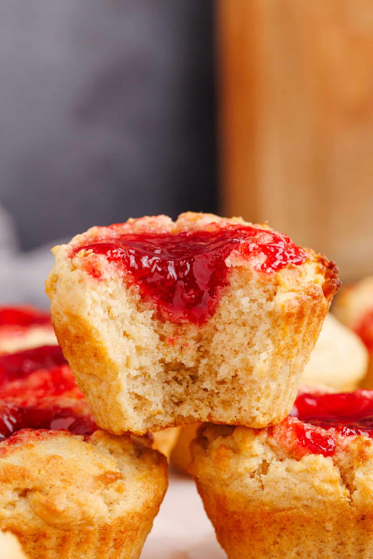 Peanut Butter and Jelly Muffins stacked with a bite taken