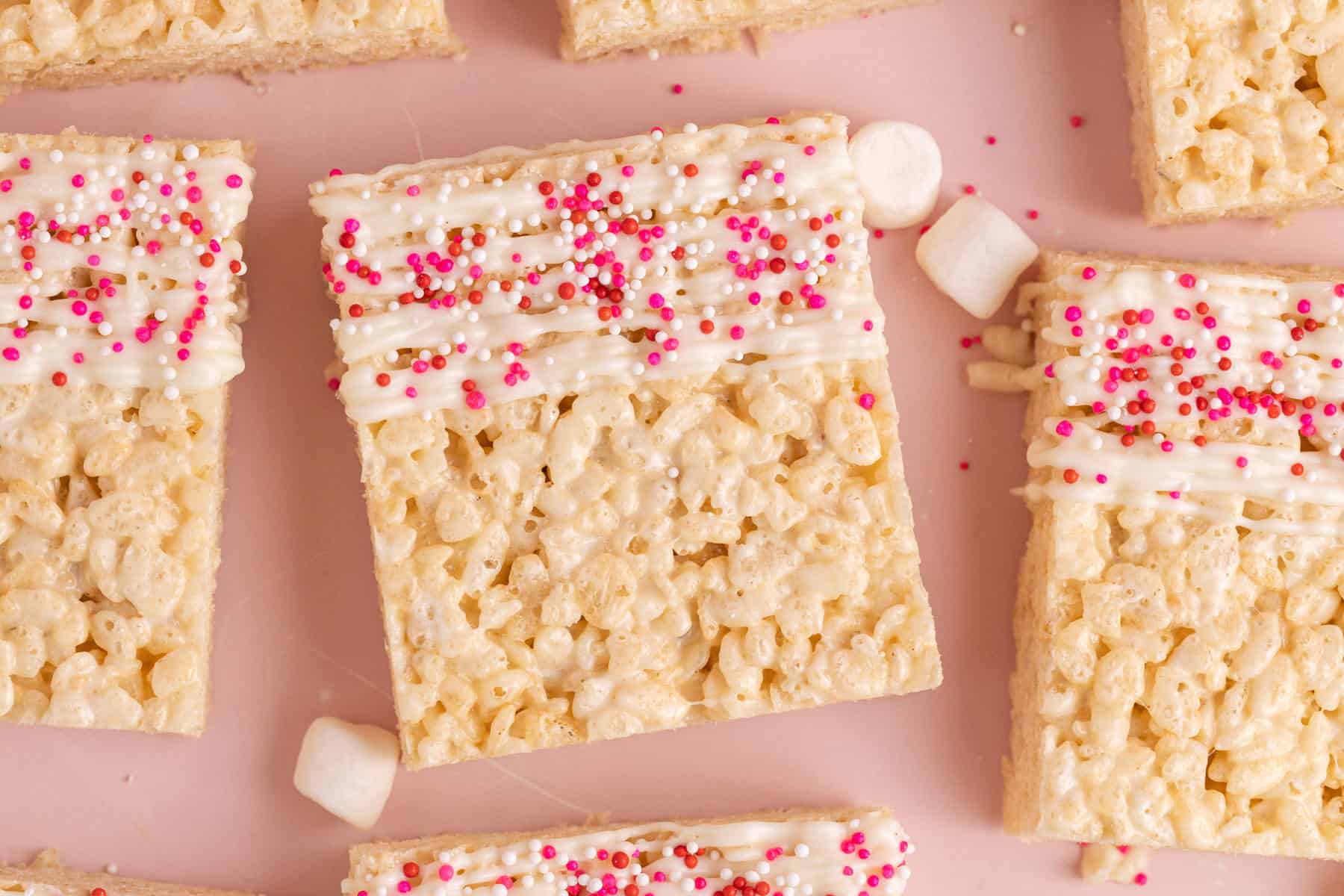 Rice Krispie Squares for Valentine's Day with white chocolate drizzle, sprinkles
