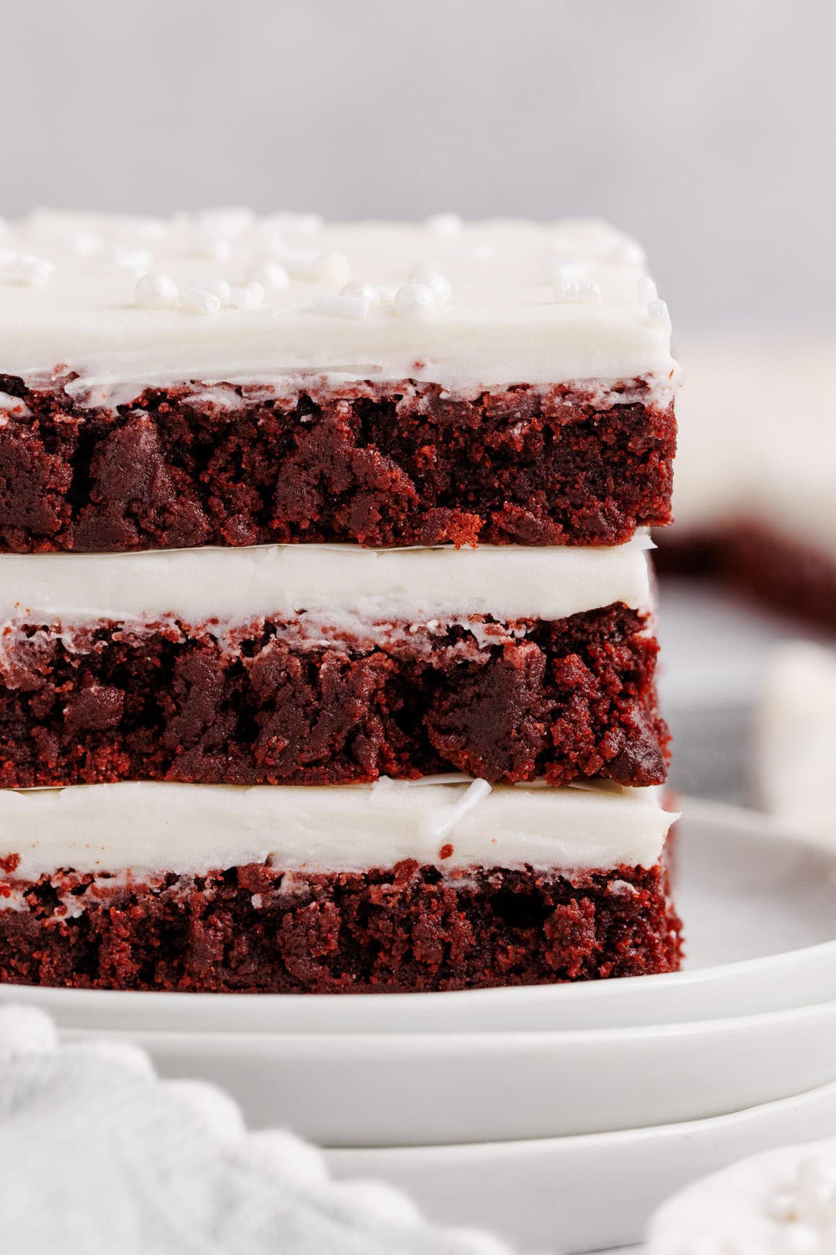 Red Velvet Cookies Bars stacked on a plate close up